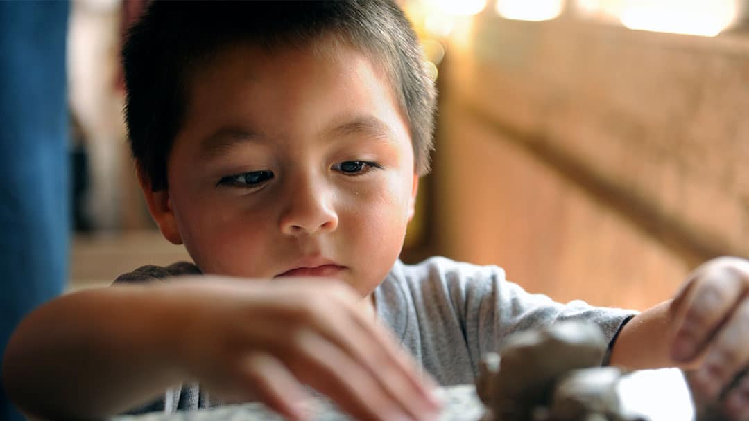 Young boy making pottery