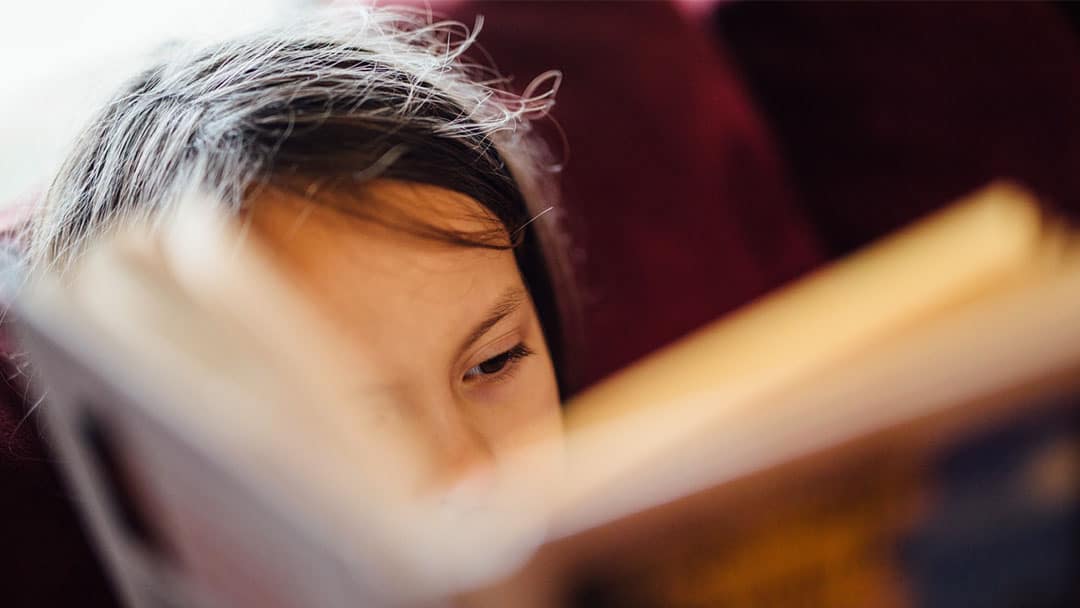 Young girl reading book